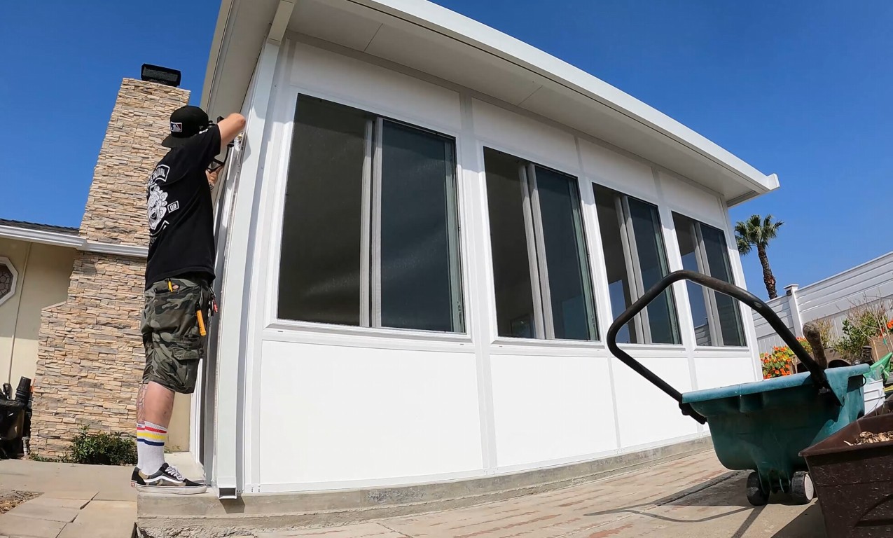 Technician repairing sunroom glass panels in Alafaya, FL